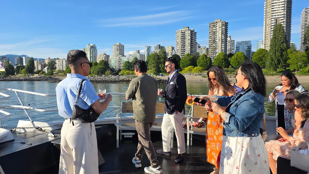 Guests enjoying drinks on Cheer's deck with skyline views