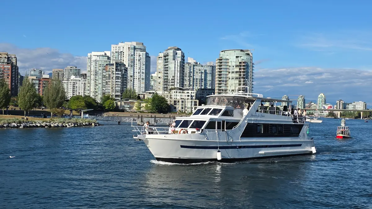 Cheer yacht on the water with the Vancouver skyline