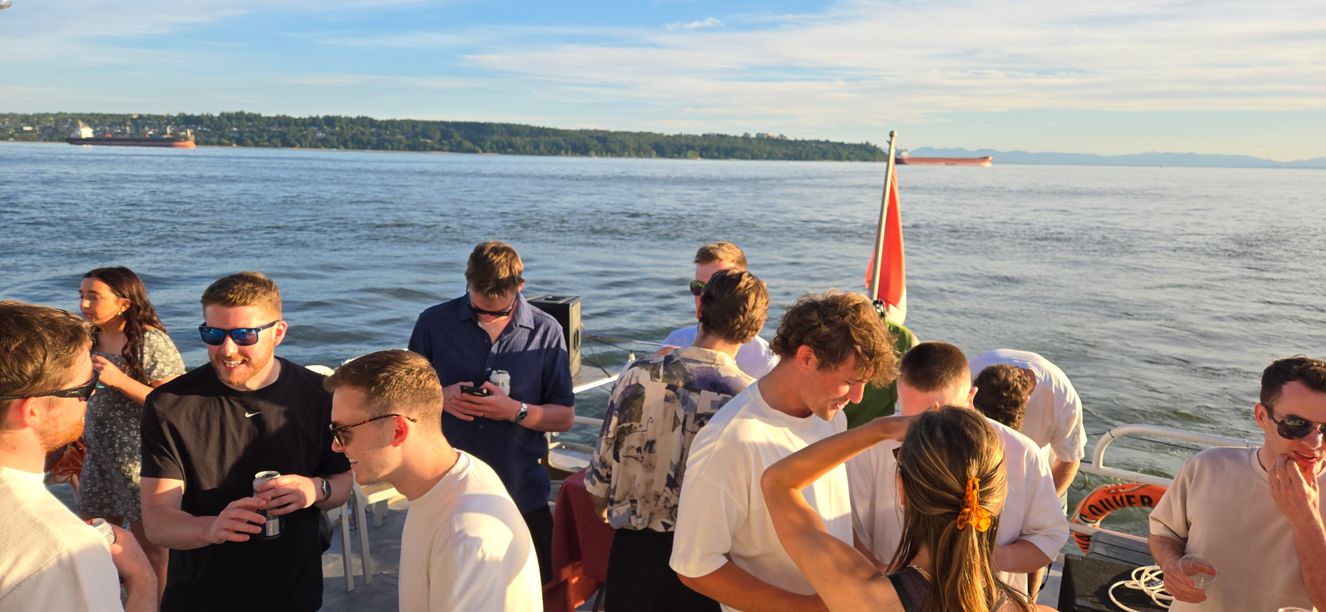 Guests enjoying sunset on deck with English Bay views