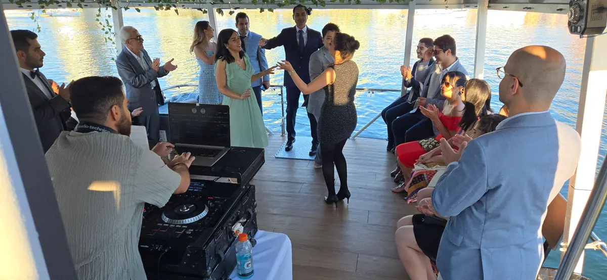 Guests celebrating on Joy's deck with a DJ